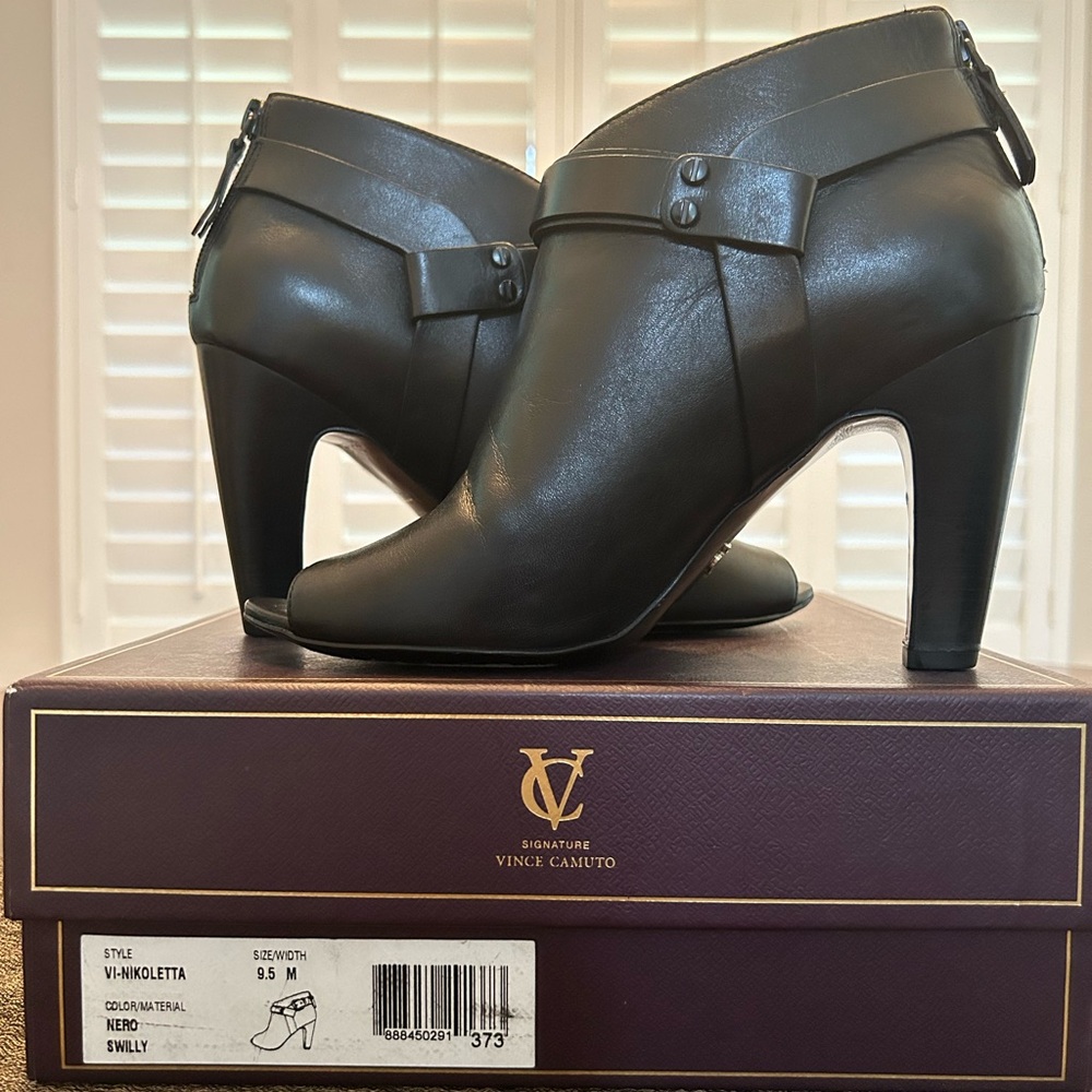 Signature Vince Camuto VI-Nikoletta bootie. Zipper back, strap detail, open toe.